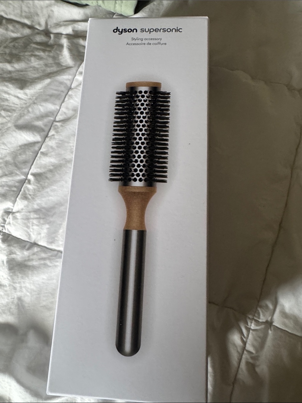 Dyson round styling brush in silver and wood-tone
